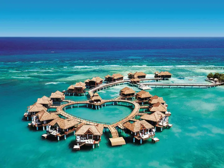 Luxury overwater resort surrounded by turquoise ocean